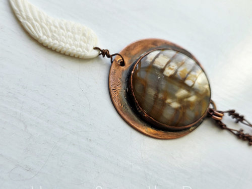 Angel wing pendant with petrified wood set in copper