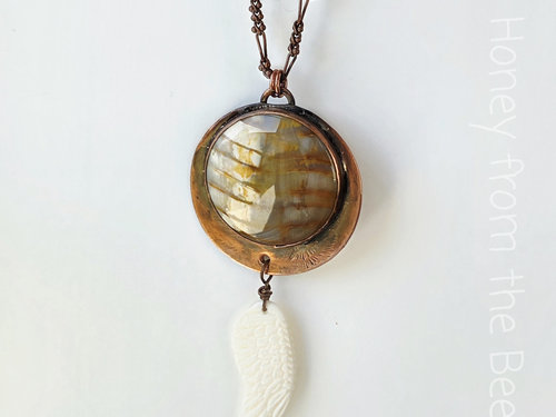 Copper pendant with petrified wood and angel wing