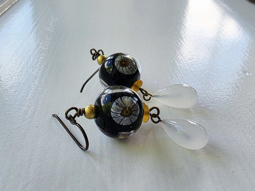 Daisy earrings feature lampwork by Lori Lochner and a vintage glass drop