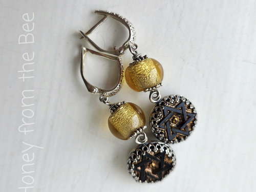 Antique black glass button earrings with star image and gold dichroic bead