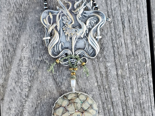 Crane pendant with green art glass cabochon