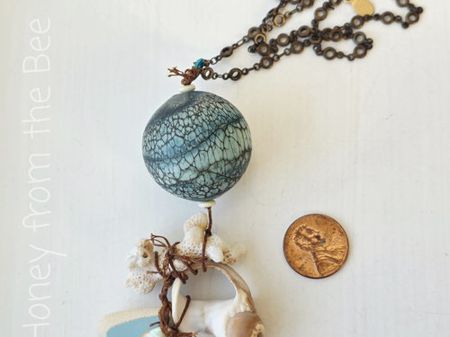 Special beach pendant features lampwork and found shells