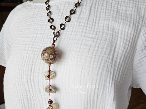 Hag stone necklace with hollow lampwork in red and cream