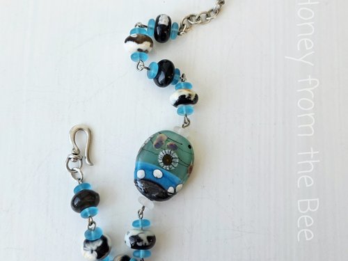 Beach bracelet in aqua, black and cream
