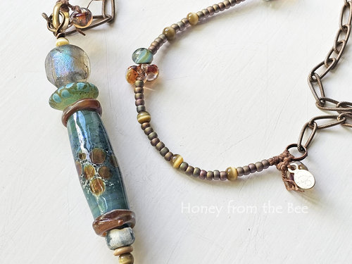 Lampwork necklace in shades of aqua, sage green, and amber