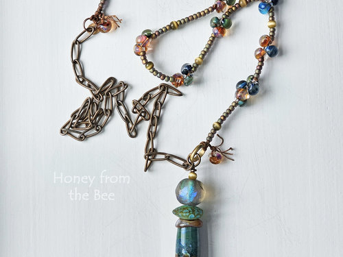 Long art necklace features stunning lampwork