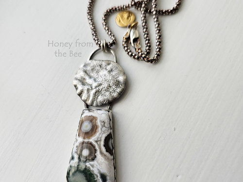 Gorgeous green, white and brown ocean jasper cabochon with reticulated sterling silver disc pendant necklace