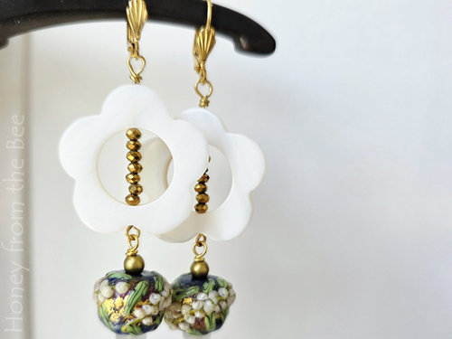 Sparkly flower earrings in navy blue and white with touch of green