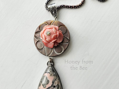 Stony Creek Jasper in peach and grey hangs below antique mother of pearl button with lotus flower center pendant necklace