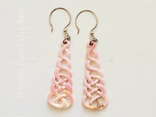 Pink shell earrings feature carved Celtic Knot