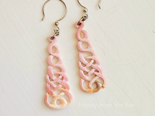 Celtic Knot earrings are carved pink shell