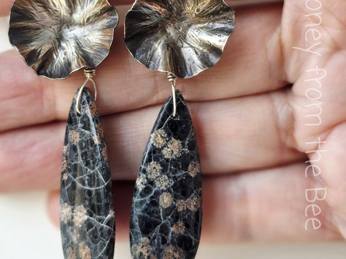 Metalworked earrings in silver and black