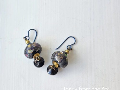 Antique button earrings with lampwork in black, yellow, purple
