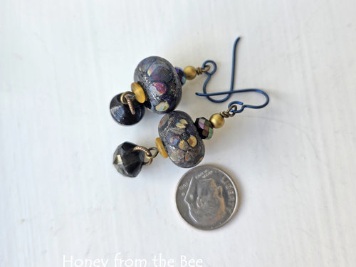 Artisan earrings feature raku lampwork and antique button drops