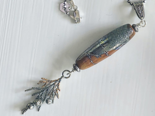 Nature inspired pendant in terra cotta and silver