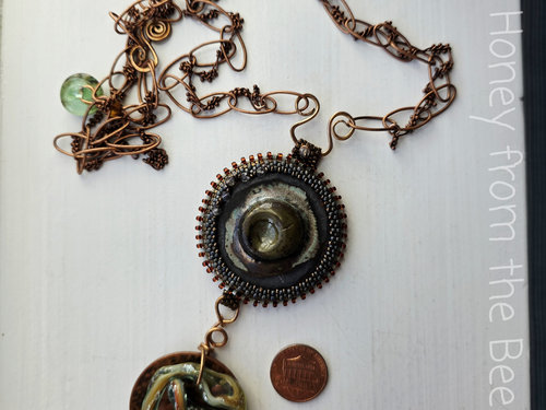 One of a kind artisan necklace is mixed media with copper, lampwork and ceramic