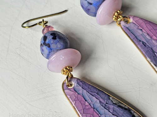 Statement earrings feature lampwork in purple and pink