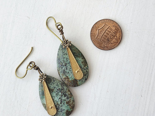 Tribal earrings feature turquoise and brass