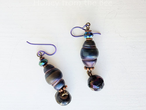 Dark peacock colored earrings in organic shape