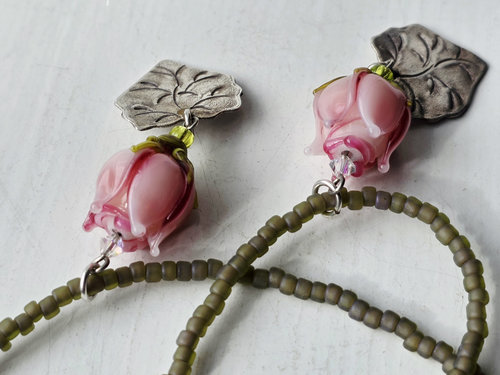 Pink rose necklace features lampworked rosebud and silver leaf dangle