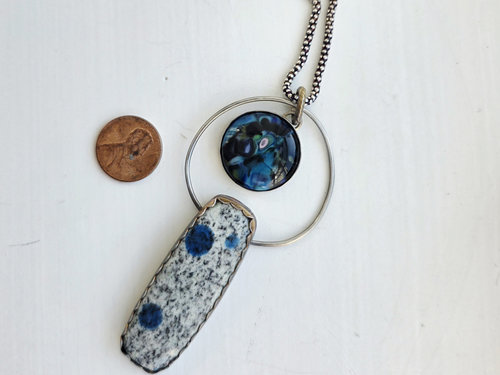 Blue and silver necklace features K2 granite and glass cabochon