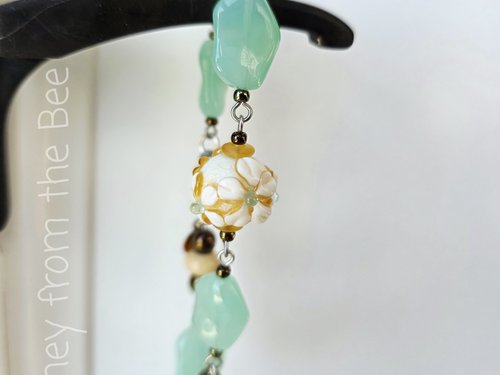 Celadon and yellow bracelet with daisy lampwork bead focal