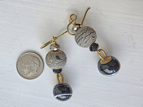 Antique button earrings also feature lampwork in black and gold