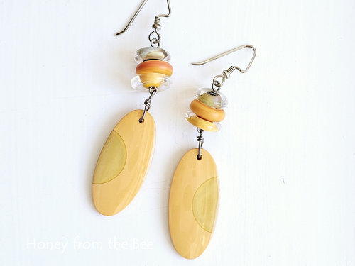 Orange lampwork earrings in discs and ovals