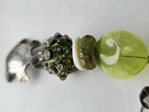 Green lampwork pendant with silver turtle