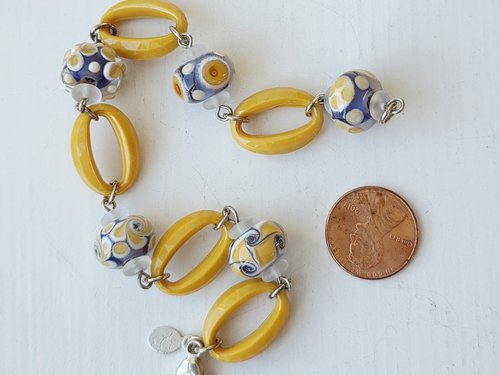 Artisan bracelet features lampwork in lavender and yellow
