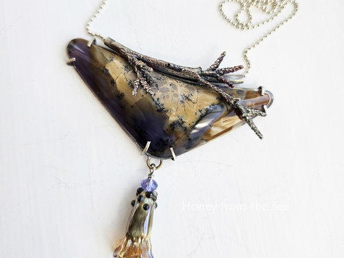 Statement necklace in purple and golden browns with nature motifs pendant necklace