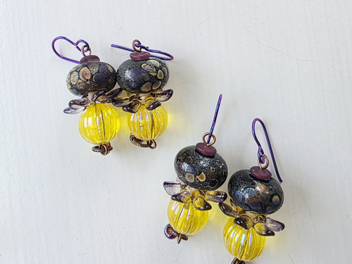 Joyful earrings in yellow and purple feature lampwork glass