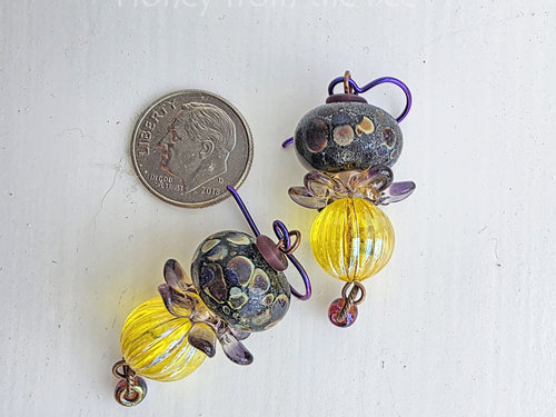 Artisan earrings feature lampwork in purple and yellow