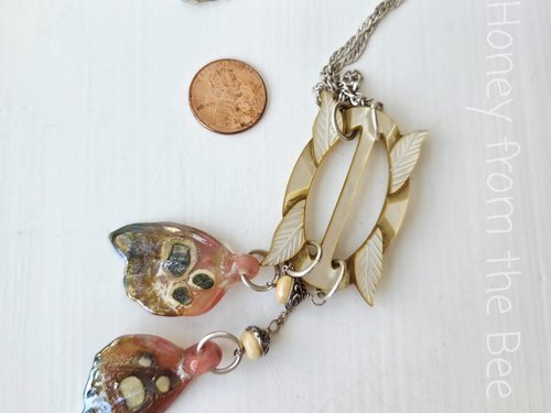 Sepia toned necklace with rosie pink butterfly wings