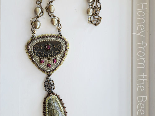 Art necklace is bead embroidered and features antique brass drawer pull and moss agate