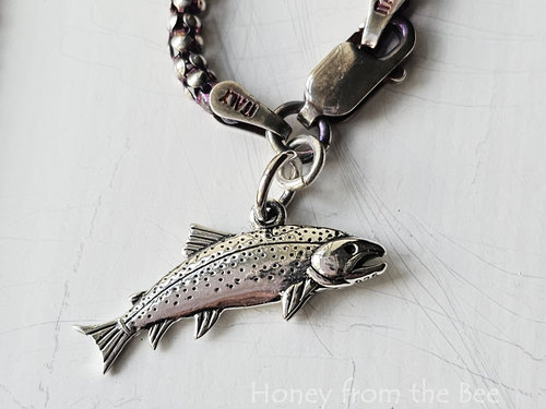 Sterling silver salmon charm represents the fish that got away.