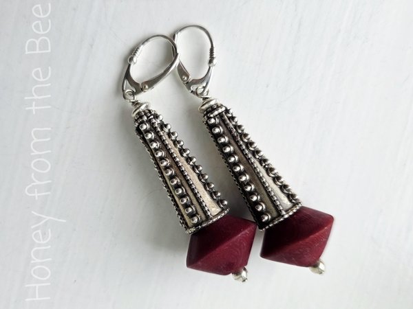 Sterling silver earrings with dark red bead