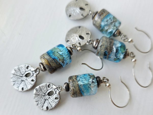Beach earrings feature sand dollar charms and lampwork