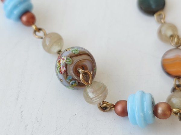 orange and blue bracelet features lampwork bead