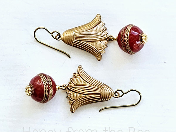 Dangle earrings feature vintage brass water lily and red lucite bead