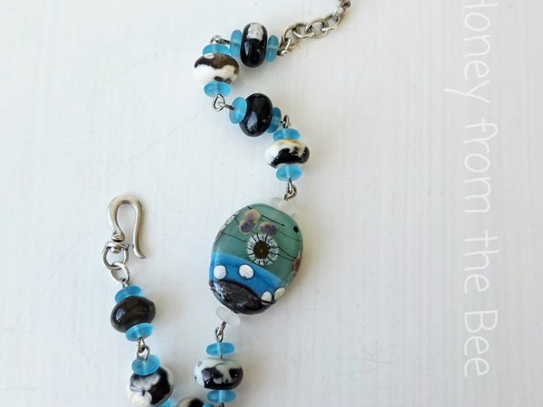 Beach bracelet in aqua, black and cream
