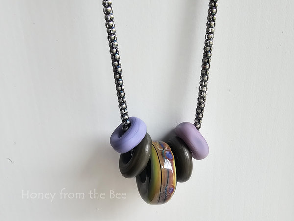 Lampwork necklace in purple, green and bronze