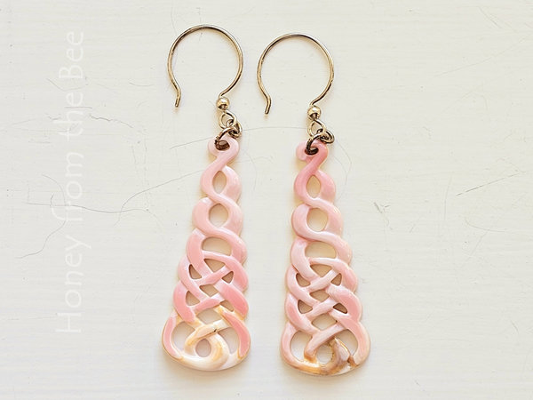 Pink shell earrings feature carved Celtic Knot