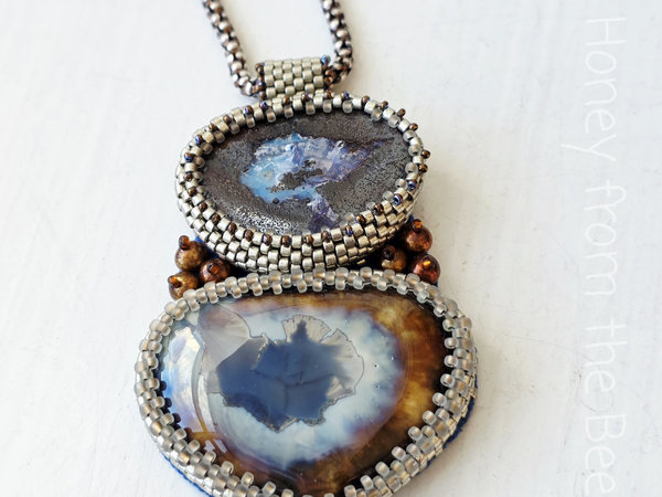 Boulder Opal pendant is bead embroidered with ceramic focal
