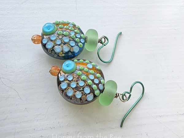 Colorful earrings in orange, green and aqua