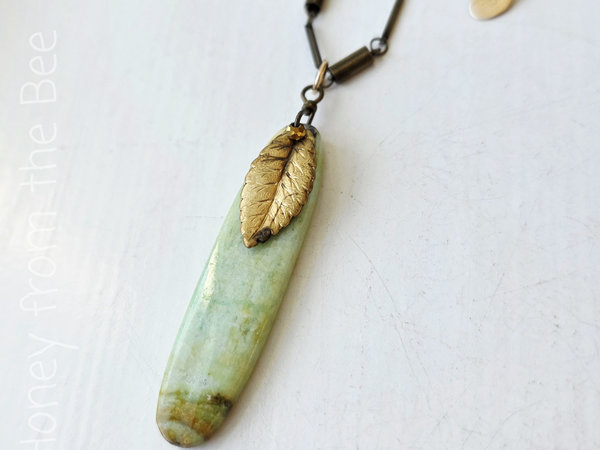 Green gemstone pendant with vintage brass leaf