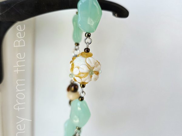 Celadon and yellow bracelet with daisy lampwork bead focal